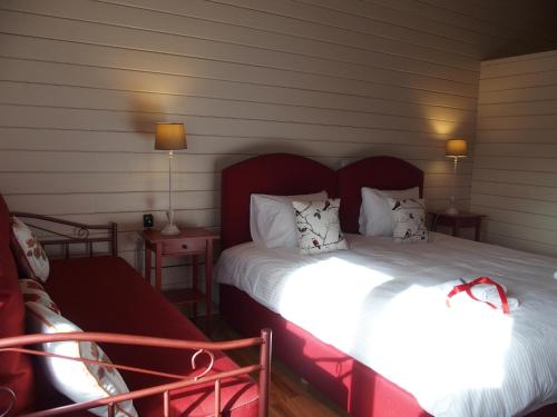 a bedroom with two beds and a couch and lamps at Ktima Noosfera Wellness & Retreat Center in Nees Vrisoules