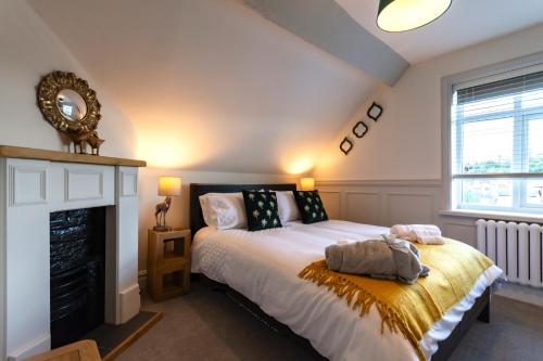 a bedroom with a bed and a fireplace at The Clockhouse Bewdley in Bewdley
