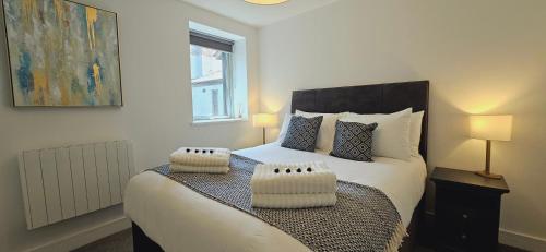 a bedroom with a large bed with two pillows at Lamberts House - 2 Bed, 2 Bathroom in Leeds