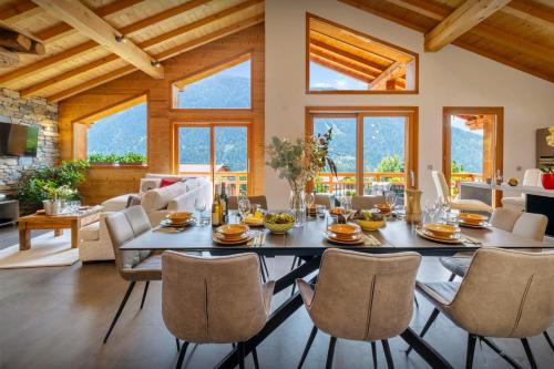 a dining room with a table and chairs at Les Moulins D'Angelina - OVO Network in Séez