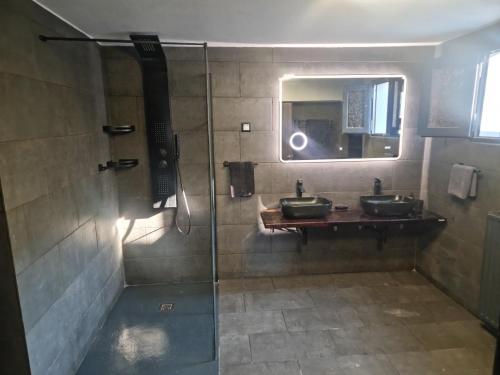 a bathroom with two sinks and a shower at Andronike's Villa in Sami