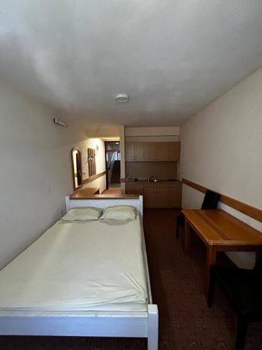 Apartmani Helda في فلاسيتش: غرفة نوم بسرير ومكتب وطاولة