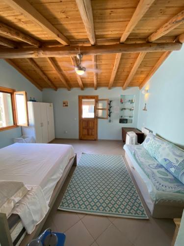 a bedroom with a bed and a wooden ceiling at Tiny Big House in Fanari