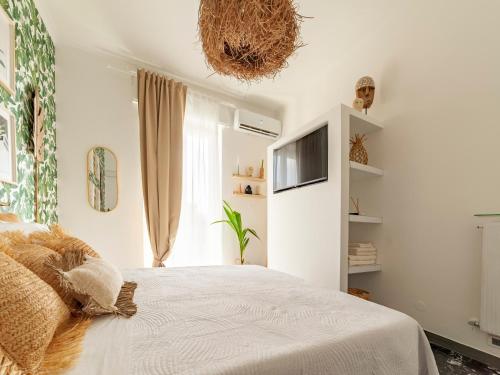 a bedroom with a bed and a tv on the wall at LA CASITA in Alassio