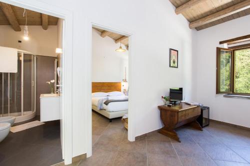 a bathroom with a bed and a sink and a toilet at Calabrialcubo Agriturismo in Nocera Terinese