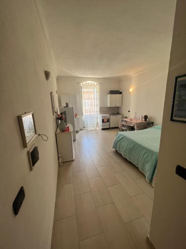 een slaapkamer met een bed en een tegelvloer bij Monolocale via centrale in Sorso