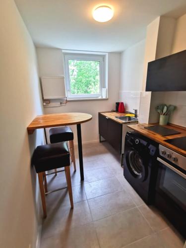a small kitchen with a table and a stove at Monteurzimmer Berlin Neukölln in Berlin