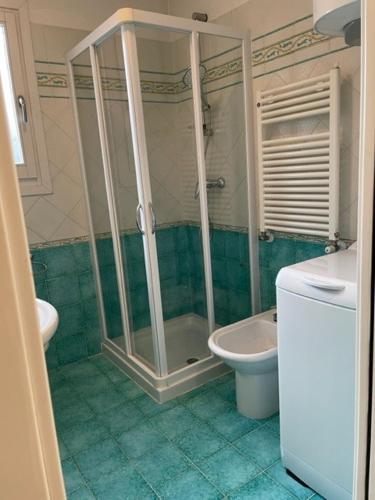a bathroom with a shower and a toilet at Corte del Mare in Aprilia Marittima