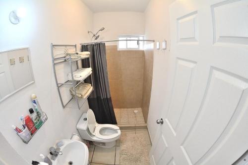 a small bathroom with a toilet and a shower at Modern 1-bedroom Apartment in Cabo San Lucas in Cabo San Lucas