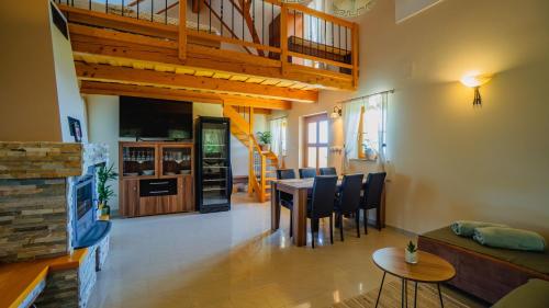 a living room with a table and chairs and a staircase at Villa VINEYARD in Velika Nedelja