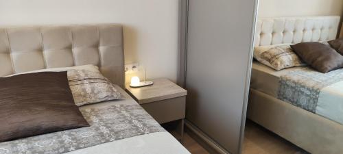 a small bedroom with a bed and a mirror at SWEET HOME - central cozy apartment in Cluj-Napoca