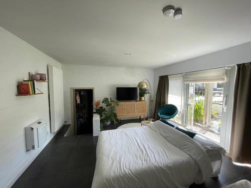 a bedroom with a white bed and a window at Perfect getaway in Bruges! in Bruges