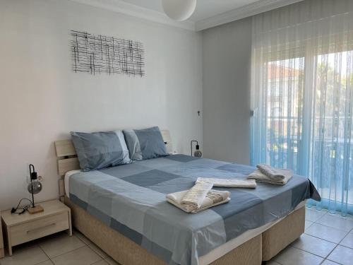 a bedroom with a bed with two towels on it at Lovely 2-Bed Apartment in Side - Ilica in Side