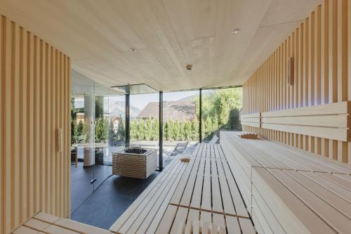 a large room with wooden benches and glass windows at Alpenhotel Montafon & SPA in Schruns