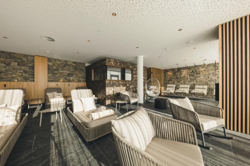 a salon with white chairs and a waiting room at Alpenhotel Montafon & SPA in Schruns