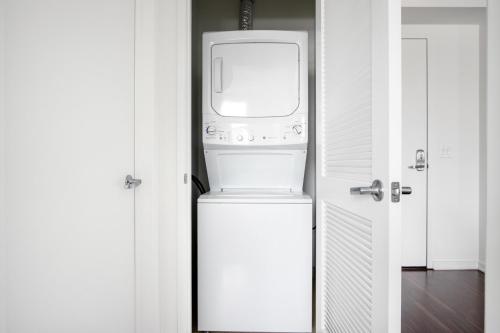 a washer and dryer sitting on top of a refrigerator at SoMa 2BR w Gym Roofdeck nr Pinterest SFO-332 in San Francisco