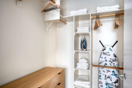 a bathroom with a closet with a surfboard and towels at 1BR Mission Bay w Gym nr Caltrain SFO-25 in San Francisco