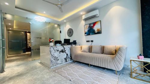 a living room with a couch and a counter at ZEN Suites Gurgaon - LUXE Stays Collection in Gurgaon