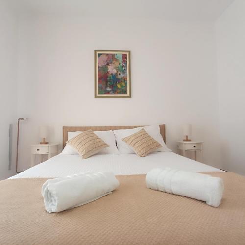 a white bed with two pillows on top of it at Villa Fragola 3 in Doli