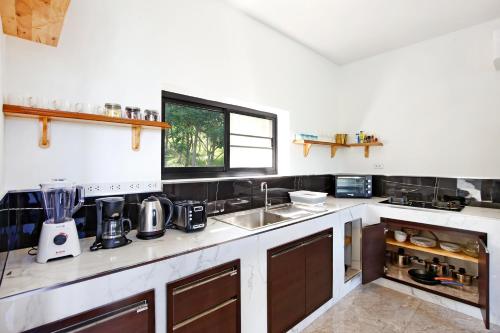 a kitchen with a sink and a counter at 2 Bays Villa in Thong Nai Pan Yai