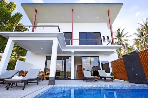 a villa with a swimming pool and a house at 2 Bays Villa in Thong Nai Pan Yai
