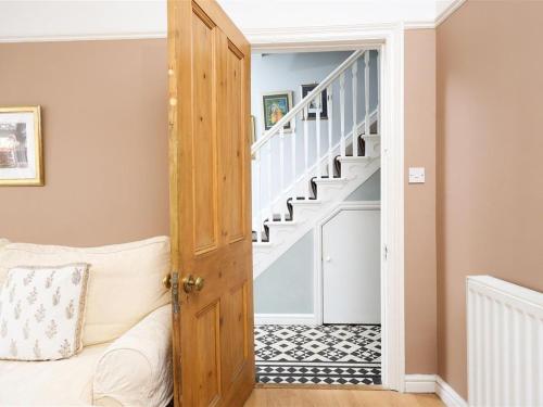a room with a wooden door and stairs at Comfortable Bristol Escape near Gloucester Road in Bristol