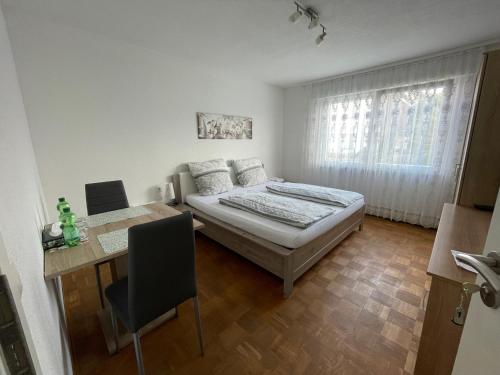 a bedroom with a bed and a table and a desk at Nita in Frickenhausen