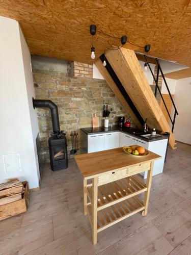 a kitchen with a wooden table and a stove at Dom Coacha i Mentora in Wysowa-Zdrój