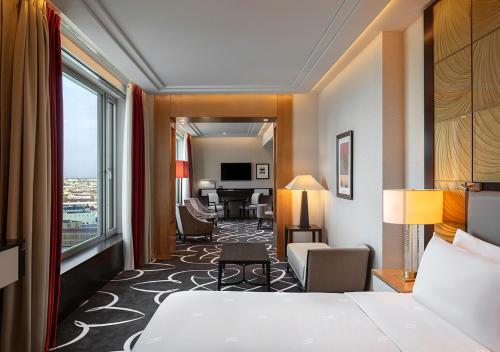 a hotel room with a bed and a large window at Waldorf Astoria Berlin in Berlin