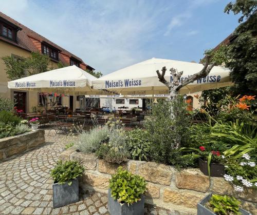 ein Restaurant mit Pflanzen vor einem Gebäude in der Unterkunft Trobischhof in Dresden