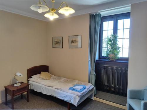 a small bedroom with a bed and a window at Pokój 315 dla dwóch osób z prywatną łazienką - Piotrkowska 262-264 in Łódź