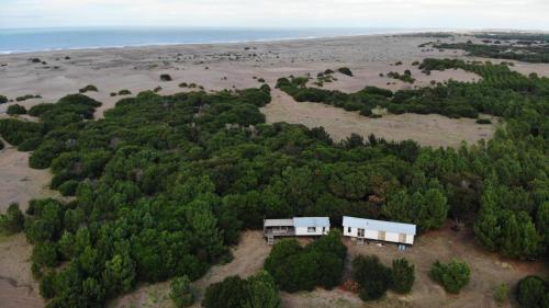 an aerial view of a house in a forest at La Luisa in Balneario Reta