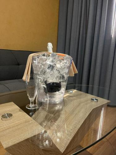 a table with glasses and a plastic container on it at Hotel-Asador Montes Oretanos in Pulgar