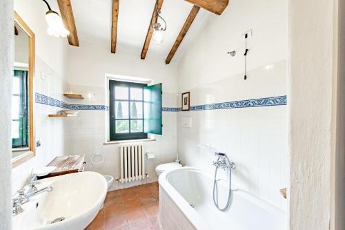 a bathroom with a tub and a sink at Semidetached Villa Shared Pool - Happy Rentals in Colle