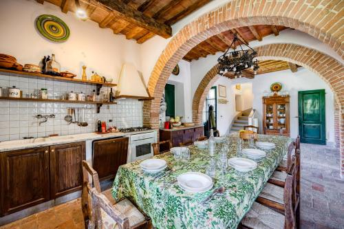 a kitchen with a long table with chairs and a counter at Semidetached Villa Shared Pool - Happy Rentals in Colle