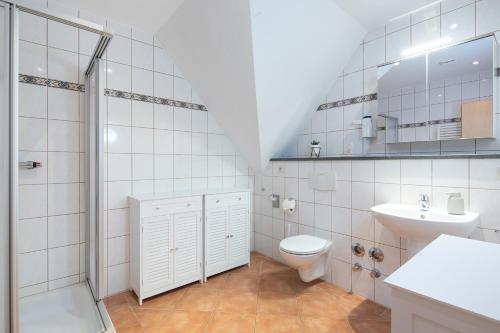 un bagno con wc, lavandino e doccia di Hafen Seedorf Haus 1 a Seedorf