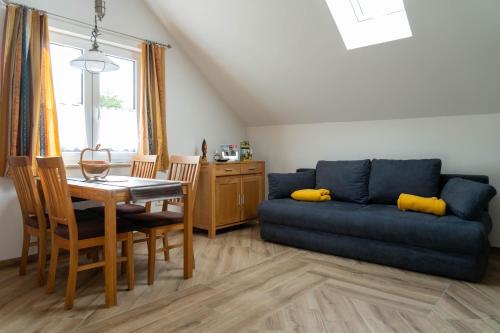 a living room with a blue couch and a table at LOFT 2 in Thürnthal