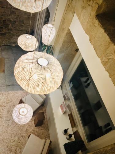 an overhead view of a room with three pendant lights at Carris Casa de la Troya in Santiago de Compostela