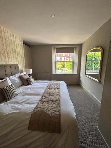 a large bedroom with a large bed with a window at Luxury Apartment - Great Location in Ecclesall