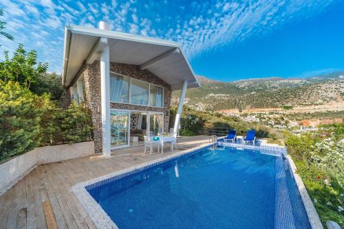 a house with a swimming pool in front of a house at Likya Pavilion Hotel in Kas