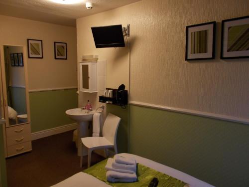 a room with a bathroom with a sink and a toilet at Delamere Hotel in Blackpool