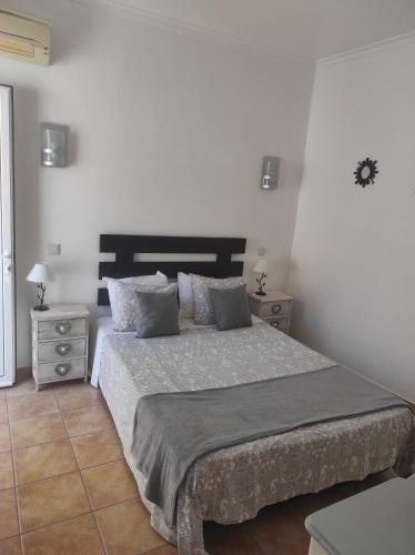 a bedroom with a large bed and two night stands at Bela Vista in Olhão