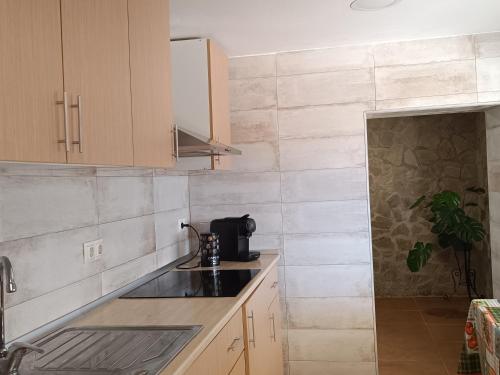 a kitchen with wooden cabinets and a counter top at El Mirador"Venerable Escuder" in Cocentaina