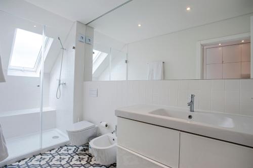 a white bathroom with a sink and a toilet at Eighteen21 Houses - Secluded Charm Cottage in Quinta Velha in Sintra