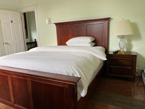 a bedroom with a large bed with a wooden headboard at Malden rooms in Malden