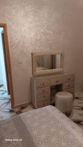 a bedroom with a dresser and a mirror at S&R Appartements in M'diq