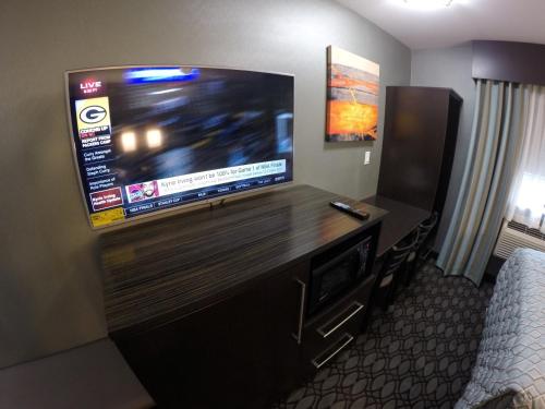 a large flat screen tv in a hotel room at Red Carpet Inn Elmwood in Elmwood Park