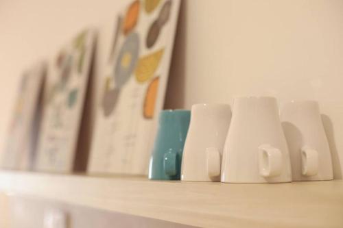 a shelf with three coffee cups on it at Crystal House@BaliResiden@Near Jonker#Heritage in Melaka
