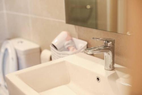 a bathroom sink with a faucet and a mirror at Crystal House@BaliResiden@Near Jonker#Heritage in Melaka