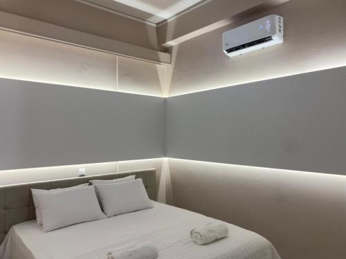 a bedroom with a bed with a air conditioner on the ceiling at Comfortable Apartment Near to Metro & Hospitals in Athens